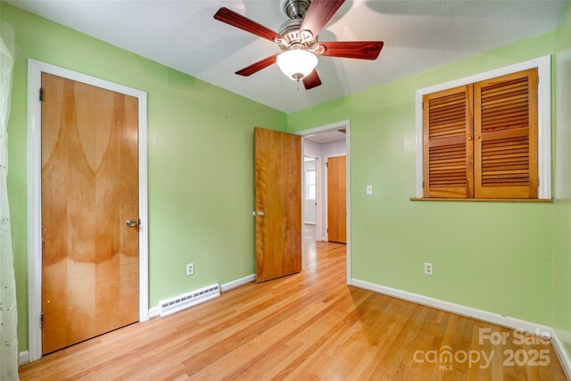 2111 Parkdale Ave, Gastonia, NC 28052 - unfurnished bedroom featuring baseboards, wood finished floors, and ceiling fan