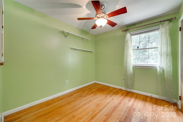 2111 Parkdale Ave, Gastonia, NC 28052 - spare room with baseboards, wood finished floors, a ceiling fan, and a textured ceiling