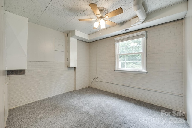 2111 Parkdale Ave, Gastonia, NC 28052 - carpeted spare room featuring brick wall, a ceiling fan, and a paneled ceiling