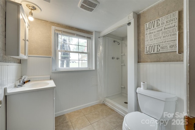 2111 Parkdale Ave, Gastonia, NC 28052 - full bathroom featuring a wainscoted wall, toilet, tile patterned floors, vanity, and a shower