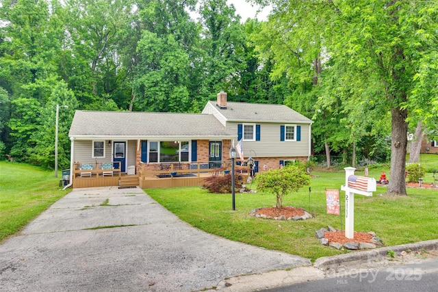2111 Parkdale Ave, Gastonia, NC 28052 - tri-level home with a porch, a chimney, a front lawn, driveway, and brick siding