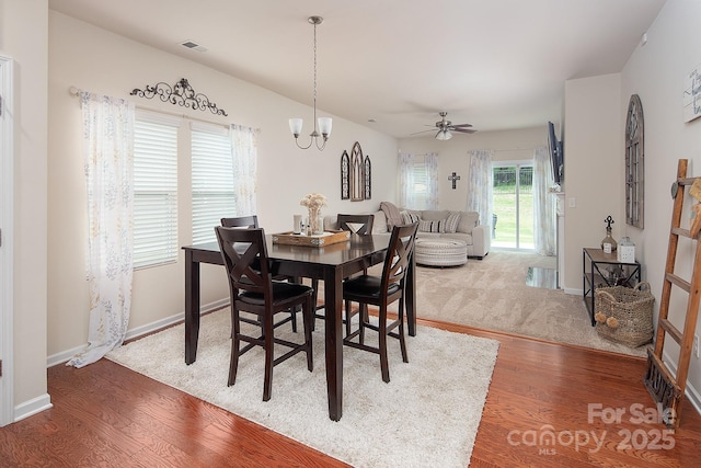 7328 Strawberry Fields Ln, Charlotte, NC 28278 - dining room with wood finished floors, a chandelier, ceiling fan, and baseboards