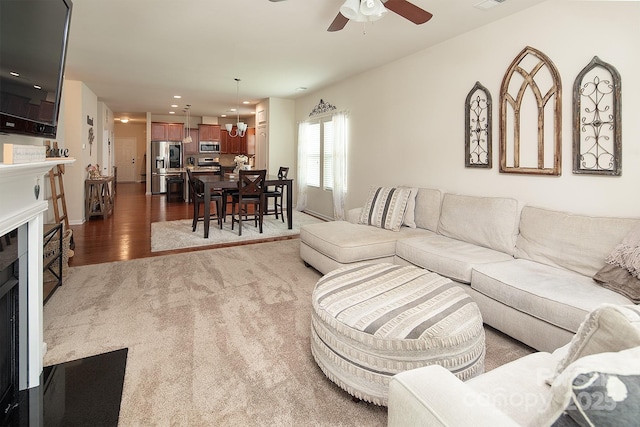 7328 Strawberry Fields Ln, Charlotte, NC 28278 - living room with a fireplace, ceiling fan, wood finished floors, carpet floors, and recessed lighting