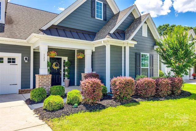 129 Hawks Creek Pkwy, Fort Mill, SC 29708 - view of front of home featuring a front lawn, a porch, roof with shingles, and an attached garage