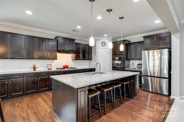129 Hawks Creek Pkwy, Fort Mill, SC 29708 - kitchen with appliances with stainless steel finishes, light stone counters, a kitchen breakfast bar, crown molding, and pendant lighting