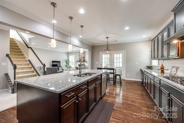 129 Hawks Creek Pkwy, Fort Mill, SC 29708 - kitchen featuring a fireplace, light stone countertops, an island with sink, appliances with stainless steel finishes, and decorative light fixtures