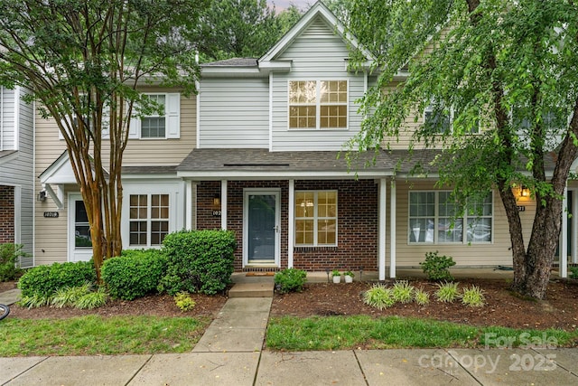 10223 Reindeer Way Ln, Charlotte, NC 28216 - view of front facade with a shingled roof and brick siding