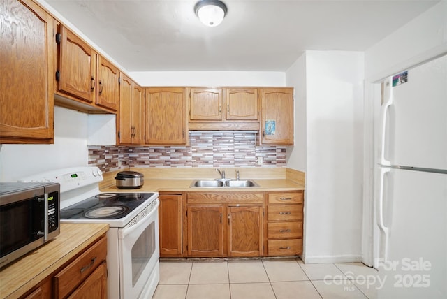 924 Carrington Dr, Charlotte, NC 28214 - kitchen featuring white appliances, a sink, light countertops, tasteful backsplash, and light tile patterned floors
