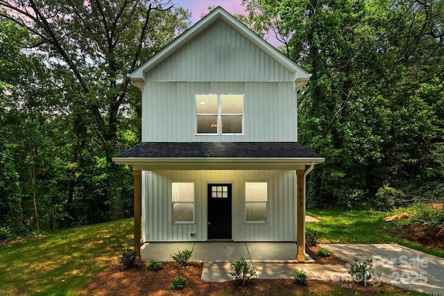 605 Poplar St, Shelby, NC 28150 - view of front of house with board and batten siding, a front lawn, a shingled roof, and a porch