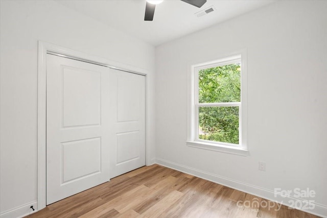 605 Poplar St, Shelby, NC 28150 - unfurnished bedroom with light wood-style flooring, baseboards, a closet, and ceiling fan