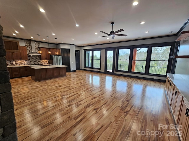 1076 Table View Dr Unit 55, Morganton, NC 28655 - unfurnished living room with ornamental molding, light wood-type flooring, recessed lighting, and a ceiling fan