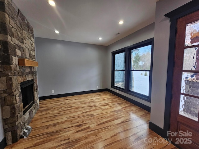1076 Table View Dr Unit 55, Morganton, NC 28655 - unfurnished living room featuring light wood-style floors, a stone fireplace, baseboards, and recessed lighting