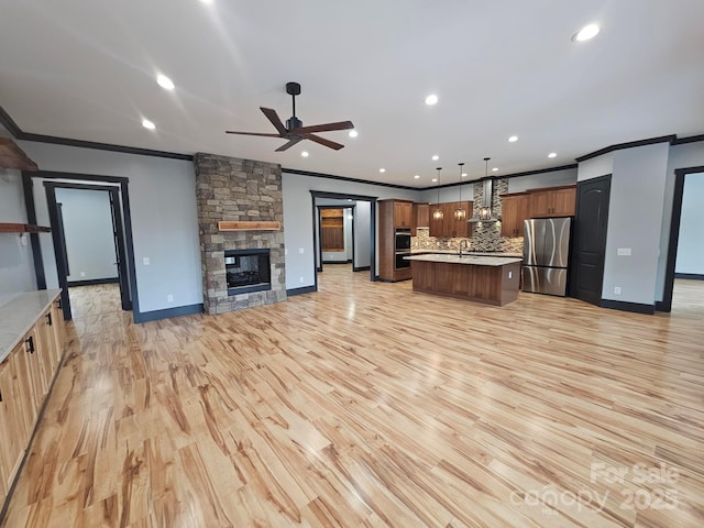 1076 Table View Dr Unit 55, Morganton, NC 28655 - kitchen with appliances with stainless steel finishes, open floor plan, ornamental molding, wall chimney exhaust hood, and a ceiling fan