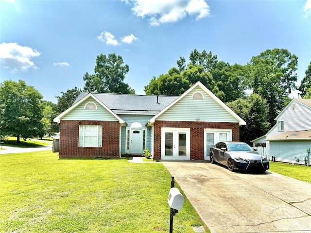 5728 Rocbridge Ln, Charlotte, NC 28208 - view of front of house with french doors, brick siding, a front lawn, concrete driveway, and central AC unit