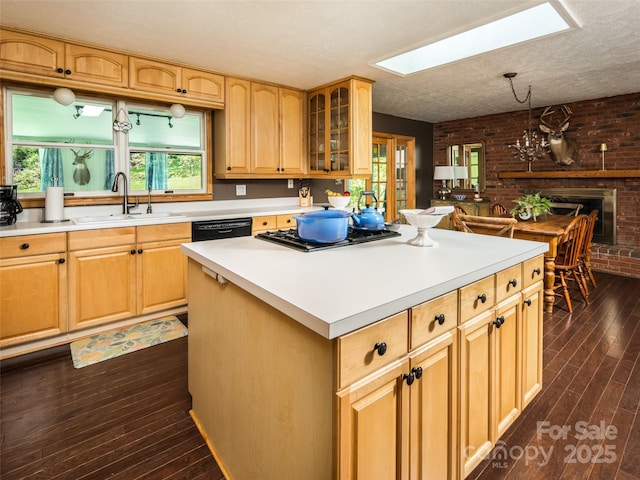 26 Melton Rd, Candler, NC 28715 - kitchen with a sink, a skylight, brick wall, dark wood finished floors, and stainless steel gas stovetop