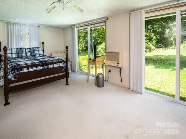 26 Melton Rd, Candler, NC 28715 - bedroom with carpet flooring, access to outside, heating unit, a textured ceiling, and a ceiling fan