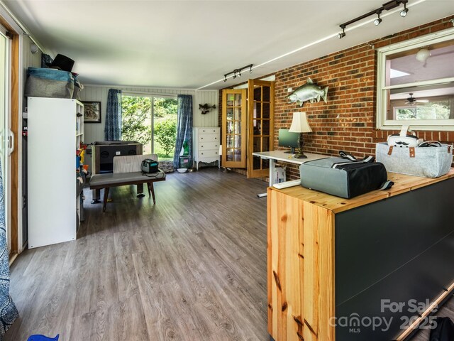 26 Melton Rd, Candler, NC 28715 - living area featuring rail lighting, wood finished floors, and brick wall