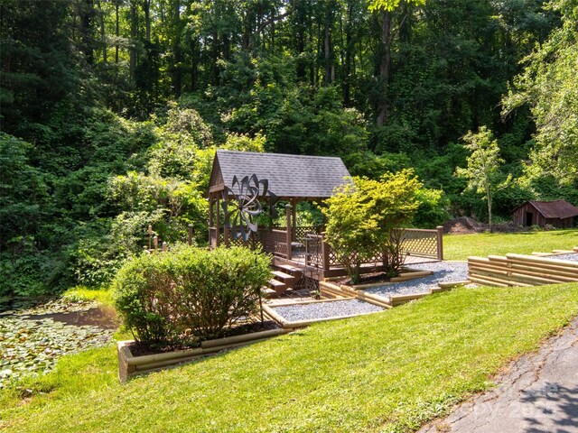26 Melton Rd, Candler, NC 28715 - view of grassy yard featuring a gazebo, a forest view, and an outbuilding