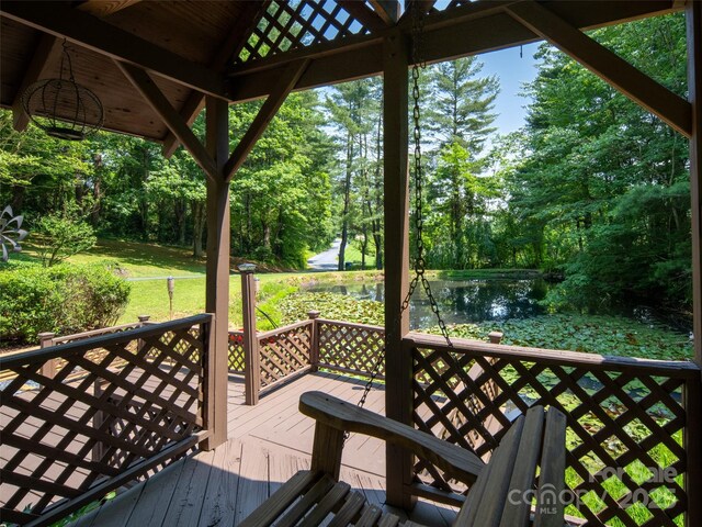 26 Melton Rd, Candler, NC 28715 - wooden deck with a water view, view of wooded area, and a lawn
