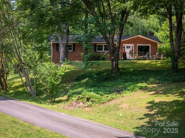26 Melton Rd, Candler, NC 28715 - single story home with brick siding, a chimney, and a front lawn