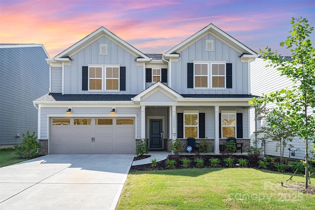 11116 Godwit Ln, Charlotte, NC 28278 - view of front of home with a porch, driveway, a lawn, board and batten siding, and a garage
