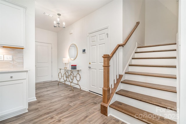 11116 Godwit Ln, Charlotte, NC 28278 - entryway with a chandelier, light wood-type flooring, stairs, and baseboards