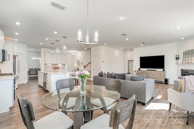 11116 Godwit Ln, Charlotte, NC 28278 - dining room featuring recessed lighting, light wood-style flooring, and a chandelier