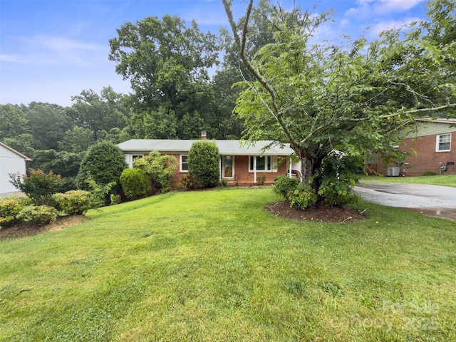 46 Donna Dale Ave SE, Concord, NC 28025 - single story home with a front yard, a chimney, and brick siding