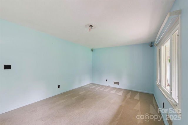 46 Donna Dale Ave SE, Concord, NC 28025 - spare room featuring light carpet, plenty of natural light, baseboards, and fire sprinkler in ceiling