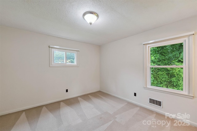 46 Donna Dale Ave SE, Concord, NC 28025 - empty room with a textured ceiling, light carpet, and baseboards