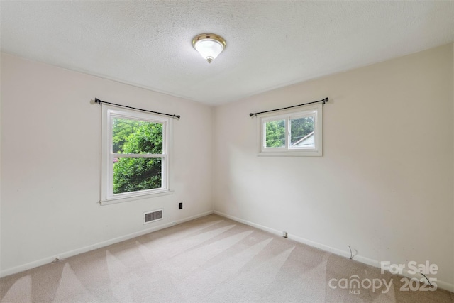 46 Donna Dale Ave SE, Concord, NC 28025 - empty room featuring plenty of natural light, baseboards, carpet floors, and a textured ceiling