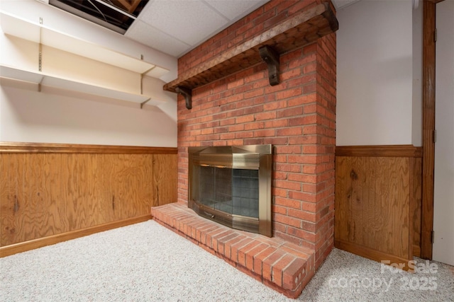 46 Donna Dale Ave SE, Concord, NC 28025 - unfurnished living room with a wainscoted wall, carpet floors, a brick fireplace, and wood walls