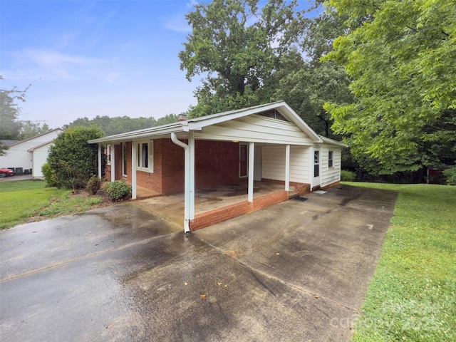 46 Donna Dale Ave SE, Concord, NC 28025 - single story home featuring driveway, brick siding, a carport, and a front yard