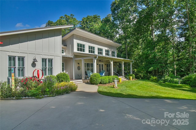 63 Greenridge Rd, Weaverville, NC 28787 - view of front facade featuring covered porch, board and batten siding, a front lawn, and ceiling fan