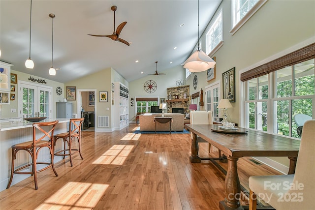 63 Greenridge Rd, Weaverville, NC 28787 - dining space with ceiling fan, high vaulted ceiling, a fireplace, light wood-type flooring, and recessed lighting