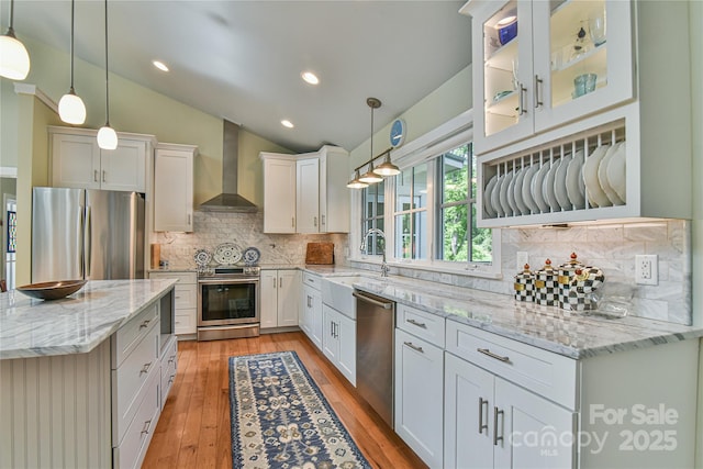 63 Greenridge Rd, Weaverville, NC 28787 - kitchen featuring appliances with stainless steel finishes, wall chimney range hood, white cabinets, light wood-style flooring, and backsplash