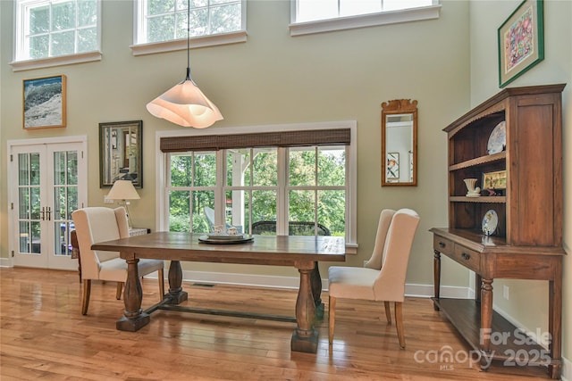 63 Greenridge Rd, Weaverville, NC 28787 - dining space featuring a towering ceiling, light wood-style flooring, plenty of natural light, and french doors
