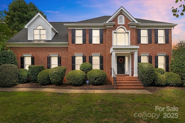 9717 Waterton Ct, Huntersville, NC 28078 - georgian-style home featuring a lawn, brick siding, and roof with shingles