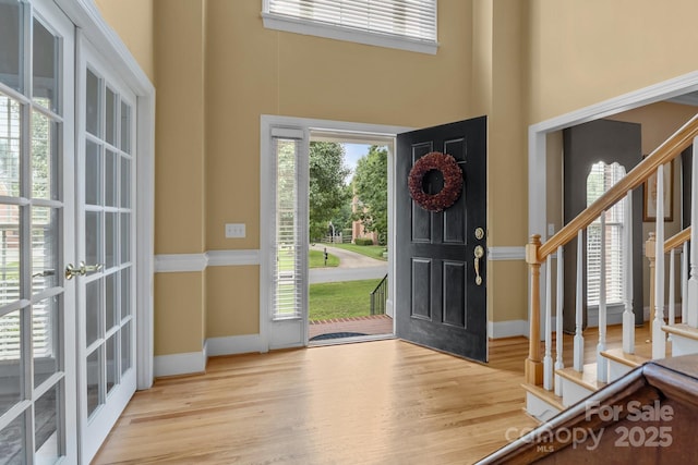 9717 Waterton Ct, Huntersville, NC 28078 - entryway featuring wood finished floors, stairway, a high ceiling, baseboards, and french doors