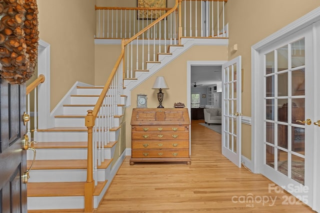 9717 Waterton Ct, Huntersville, NC 28078 - stairs with wood finished floors, french doors, a towering ceiling, and baseboards