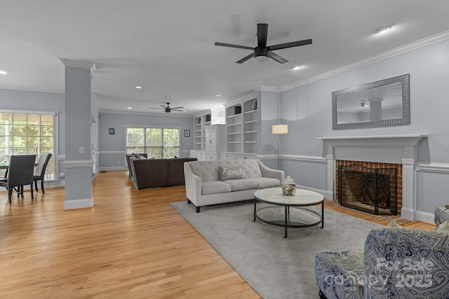 9717 Waterton Ct, Huntersville, NC 28078 - living area with a ceiling fan, recessed lighting, light wood-style flooring, crown molding, and a brick fireplace