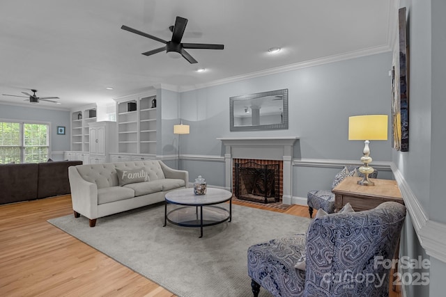 9717 Waterton Ct, Huntersville, NC 28078 - living area featuring a ceiling fan, wood finished floors, ornamental molding, a fireplace, and recessed lighting