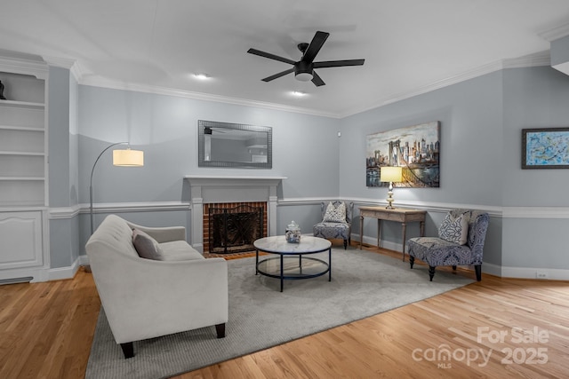 9717 Waterton Ct, Huntersville, NC 28078 - living area featuring wood finished floors, a ceiling fan, a fireplace, ornamental molding, and baseboards