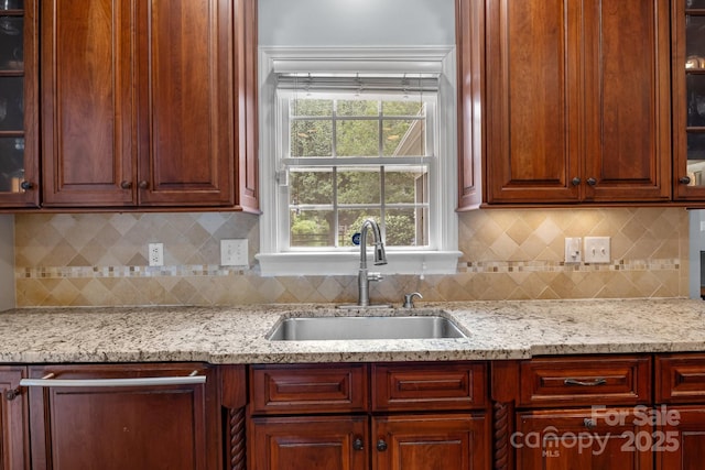 9717 Waterton Ct, Huntersville, NC 28078 - kitchen with a sink, light stone countertops, glass insert cabinets, and backsplash