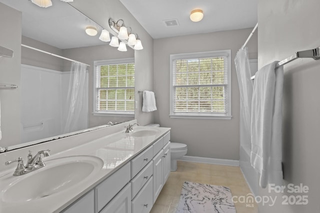 9717 Waterton Ct, Huntersville, NC 28078 - full bath with double vanity, baseboards, toilet, shower / bath combo, and tile patterned floors