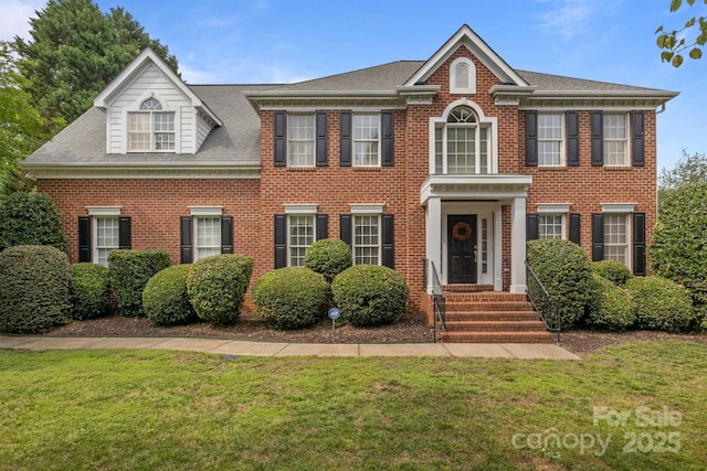 9717 Waterton Ct, Huntersville, NC 28078 - colonial home featuring a front lawn, brick siding, and roof with shingles