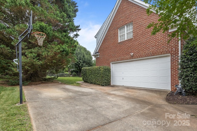 9717 Waterton Ct, Huntersville, NC 28078 - view of side of home featuring brick siding, concrete driveway, and a garage