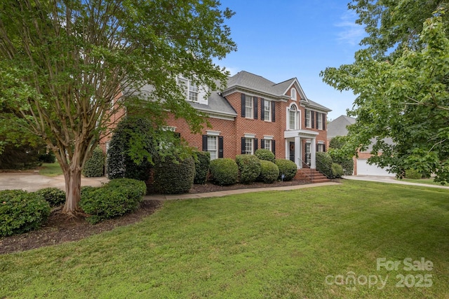 9717 Waterton Ct, Huntersville, NC 28078 - colonial inspired home with a front lawn, brick siding, and a garage