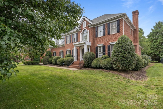9717 Waterton Ct, Huntersville, NC 28078 - colonial inspired home featuring a chimney, brick siding, and a front yard
