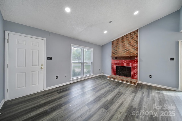 8520 Mission Hills Rd, Charlotte, NC 28227 - unfurnished living room with a textured ceiling, vaulted ceiling, wood finished floors, a fireplace, and recessed lighting